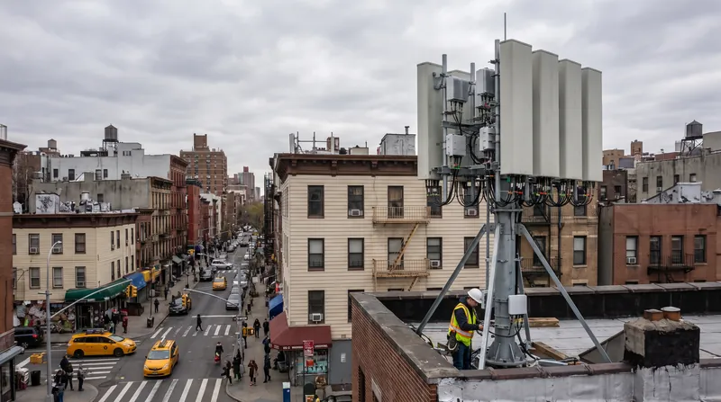 A close-up view of a modern 5G Massive MIMO rectangular antenna panel mounted on a cell tower.