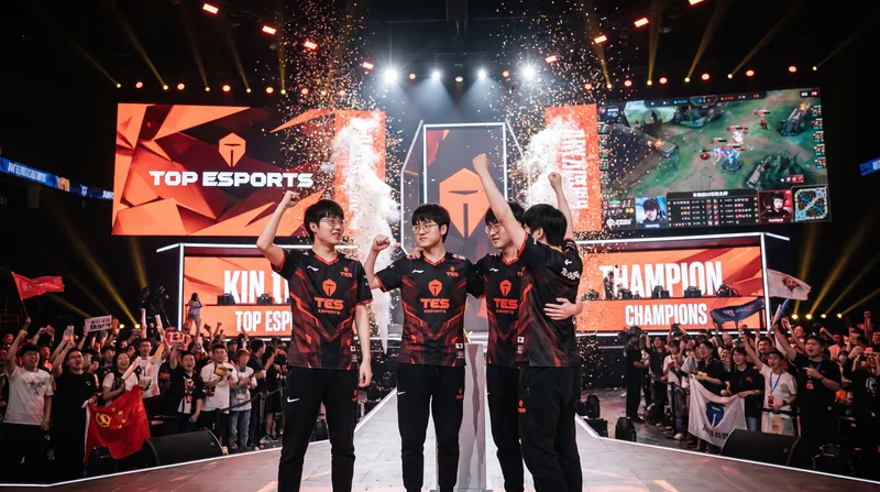 Five professional esports players in team jerseys celebrating on a brightly lit tournament stage.