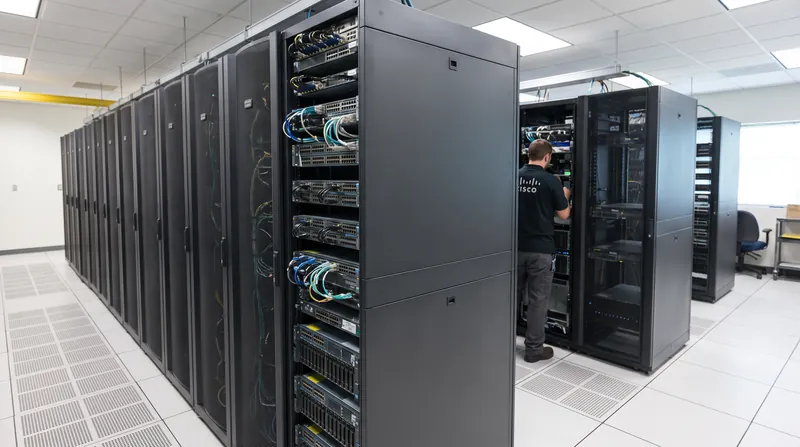 A modern enterprise data center server rack with glowing lights representing network security infrastructure.