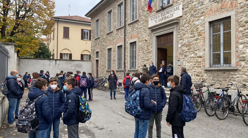 An editorial photo showing the interior of a typical Italian school classroom or school building.