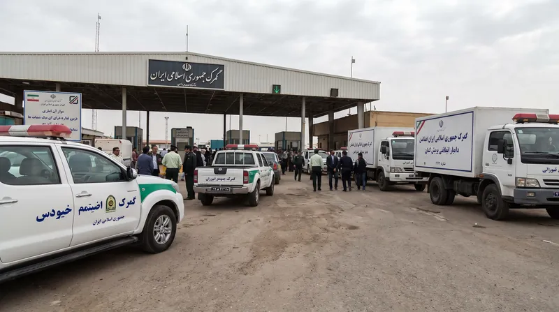 ردیف‌های طولانی از خودروهای وارداتی جدید پارک شده در محوطه یک بندر یا گمرک در ایران زیر نور آفتاب.