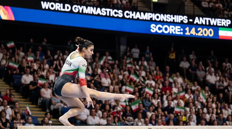 A female gymnast performing a leap on the balance beam in a brightly lit competition arena.